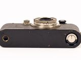 an old camera that is sitting on a white surface