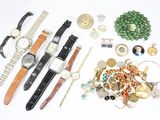 many different watches and bracelets laid out on the table