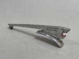 a metal stapler that is sitting on a white surface