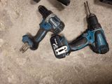 two electric tools that are laying on the floor