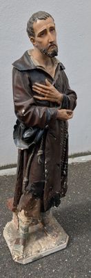 a statue of a man holding a knife and fork