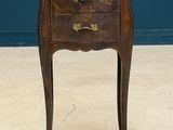 an old wooden table with three drawers and a drawer on top of it