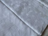 a white sheet on a bed with a white comforter on it