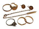 a lot of different rings and bracelets on a white background