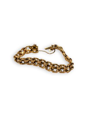 a close up of a gold chain bracelet on a white background
