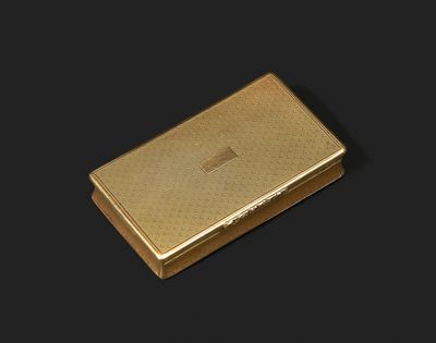 a gold cigarette case on a black background