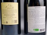 two bottles of wine sitting next to each other on a table
