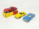 three toy cars sitting on top of a box