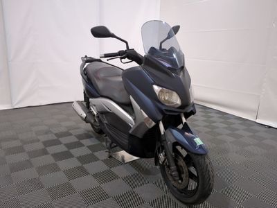 a motorcycle that is parked on a checkered floor