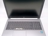 an open laptop computer sitting on top of a white surface