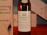 a bottle of wine sitting next to a wooden box