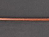 a brown pipe attached to a black wall