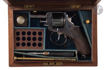 a wooden box with a gun and other items in it