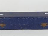 an old blue suitcase sitting on top of a white table