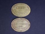 two old brass coins with the names of different companies