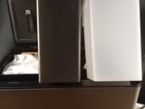 two refrigerators sitting on top of each other on a table