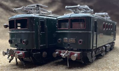 two trains that are sitting side by side on a table