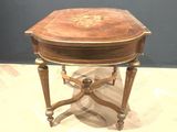 a small table with a wooden top on a white surface