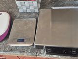 a picture of a kitchen counter top with a scale and a food processor