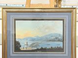 a picture of a painting hanging on a easel in a room