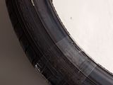 a close up of a tire on the side of a white wall