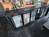 a small bar with a lot of bottles on it