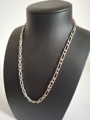 a close up of a necklace on a mannequin mannequin