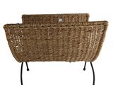 two wicker chairs with metal legs and a basket on top of them