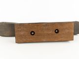 an image of a piece of wood with two holes in it