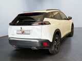 the rear end of a white suv parked in a showroom