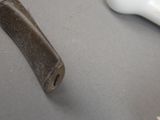 a dog bone, bone, and toothbrush sitting on a table