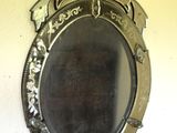 a mirror hanging on the wall with a bird on it