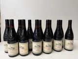 bottles of wine are lined up in a row on a table