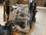 a pile of luggage sitting on a pallet in a warehouse