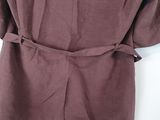 the back of a brown shirt with a belt on it
