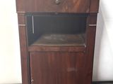 a small wooden cabinet with a marble top on the floor