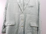 jacket hanging on a hanger on a pink wall in a room