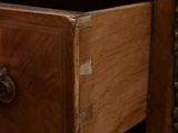 a close up of a wooden drawer with a marble top