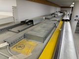 a conveyor belt in a factory with a lot of machines