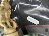 a cupcake in a plastic bag with a figurine on top of it