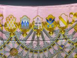 an image of a pink scarf with gold and blue designs
