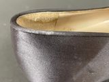 the bottom of a pair of black shoes with gold trims