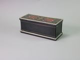 a small black box with a floral design on it