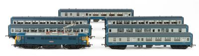 three blue and white trains sitting next to each other on a white surface