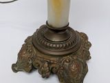 a white vase with a flower on it on a table