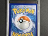 a close up of a pokemon card on a black surface