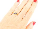 an image of a woman ' s hand with a red manicure and a gold ring