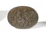 a small bronze coin sitting on a white surface