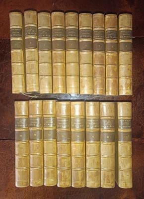 several old books are stacked on top of each other on a table