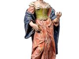 statue of a woman in a pink dress holding a book